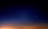 Fototapeta Zachód słońca - blue starry sky landscape at dusk against red sunset clouds background wide view of universe with stars Constellation in deep space Bright planet at twilight Astronomy nature wallpaper
