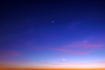 Wall Mural - blue starry sky landscape at dusk against red sunset clouds background wide view of universe with st
