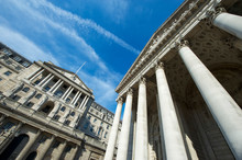 Sunny View Of The Facade Of The Bank Of England Building And Historic Royal Exchange Under Bright Blue Sky In The City Financial Center Of London, UK
