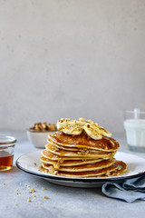 Wall Mural - Homemade delicious banana pancakes with walnuts and maple syrup.