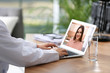 © New Africa - Doctor consulting patient online by video chat in medical office, closeup