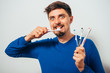 © aeroking - man holding toothbrushes