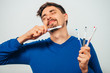 © aeroking - man holding toothbrushes