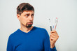 © aeroking - man holding toothbrushes