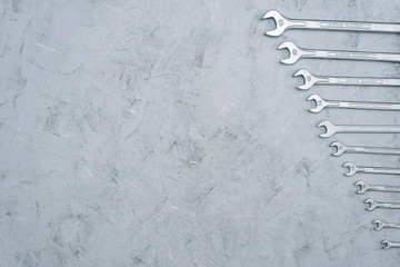 Wall Mural - Spanners. Repair tool wrench set. Set of wrenches of different sizes and diameters on a gray concrete background. Copy space. Flat lay.