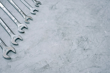 Wall Mural - Spanners. Repair tool wrench set. Set of wrenches of different sizes and diameters on a gray concrete background. Copy space. Flat lay.