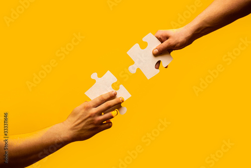 Closeup hands of man connecting jigsaw puzzle Tableau sur Toile