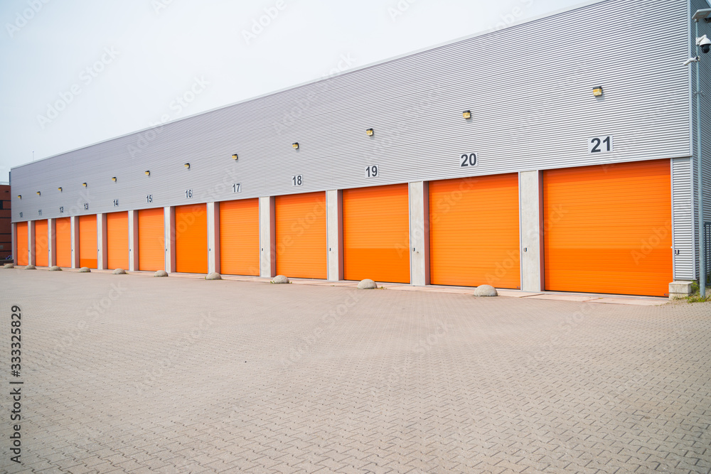 small business units with orange roller doors