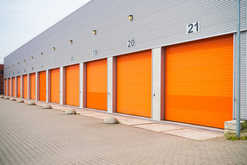 Wall Mural - small business units with orange roller doors