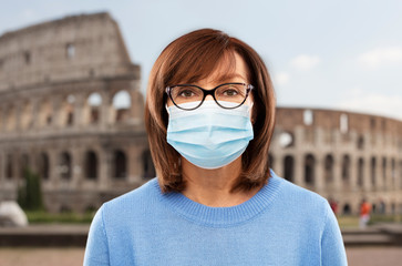 Sticker - health, safety and pandemic concept - portrait of senior woman in glasses wearing protective medical mask for protection from virus over coliseum in rome, italy background