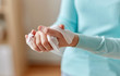 hygiene, health care and disinfection concept - close up of woman cleaning hands with antiseptic wet wipe