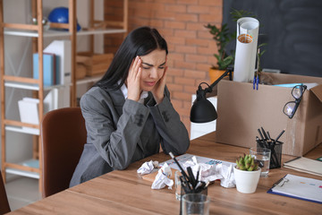 Sticker - Sad fired woman at table in office