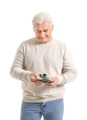 Canvas Print - Senior man with purse on white background