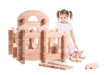 Wall Mural - Little girl playing with take-apart house on white background