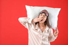 Tired Woman With Sleeping Pills And Pillow On Color Background