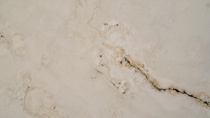 The surface of the old white wall and the color peeling off from the water stain