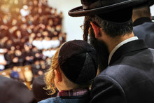 Orthodox Pilgrims Of Hasidim Listen To Their Rabbi During Mass Prayer In In A Synagogue.