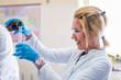 © Vladimir Borovic - Beautiful young woman scientist in laboratory working. Young female scientist doing some research.