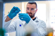 © Vladimir Borovic - Young handsome scientist in laboratory working with test tubes and doing research