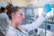 © Vladimir Borovic - Beautiful young woman scientist in laboratory working. Young female scientist doing some research.
