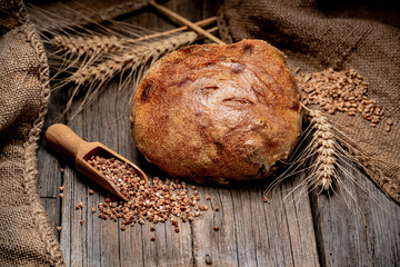 Wall Mural - Freshly baked traditional bread on wooden table.