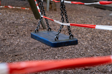 Corona crisis - Children's playground cordoned off with a red and white barrier tape in the courtyard of a residential building in Berlin-Prenzlauer Berg. So the contact ban should be enforced.