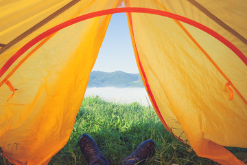 View from the tourist tent on the mountains, meadow, herbs, early in the morning when the sun rises.