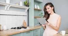Beautiful Young Woman With Digital Tablet Relaxing At Home, Happy Student Girl Using Tablet Pc In Kitchen, Resting, Relaxation, Technology, Online Shopping, Studying At Home, Learning Online Concept
