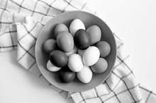 Toned Black White Color Chicken Eggs In A Plate On A Checked Kitchen Towel On A White Table