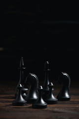 Wall Mural - chess figures on textured surface isolated on black