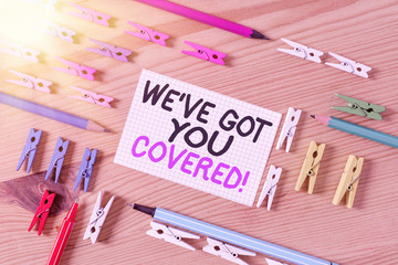 Conceptual hand writing showing We have Got You Covered. Concept meaning have done gotten or provided whatever needed Colored crumpled papers wooden floor background clothespin