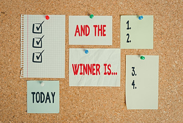 Conceptual hand writing showing And The Winner Is. Concept meaning announcing a demonstrating or thing that wins something Corkboard size paper thumbtack sheet billboard notice board