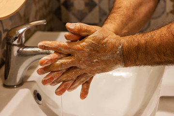 Washing hands frequently with soap and hot water for coronavirus outbreak prevention. Hygiene of hands for covid-19 pandemic protection.