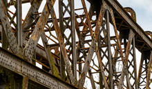 Looking Up At A Rusty Old Iron Railway Bridge