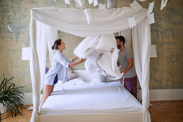 Wall Mural - Woman and man preparing canopy bed