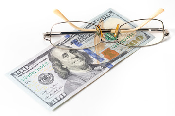 Closeup glasses on US 100 hundred dollar bill or banknote background