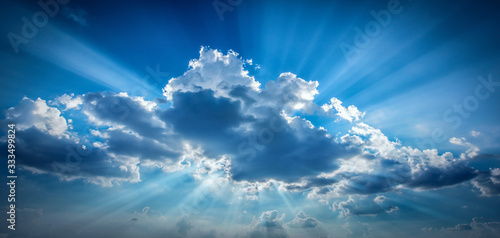 Bright sun shining in clouds on sky Poster Mural XXL