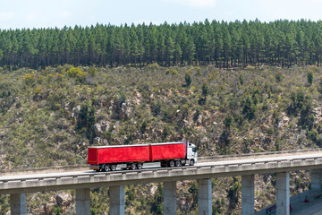 Wall Mural - Bloukrans Bridge, Eastern Cape, South Africa. Dec 2019. Bloukraans Bridge carrying a toll road 216 metres above the gorge  Passing over a red truck and trailer.