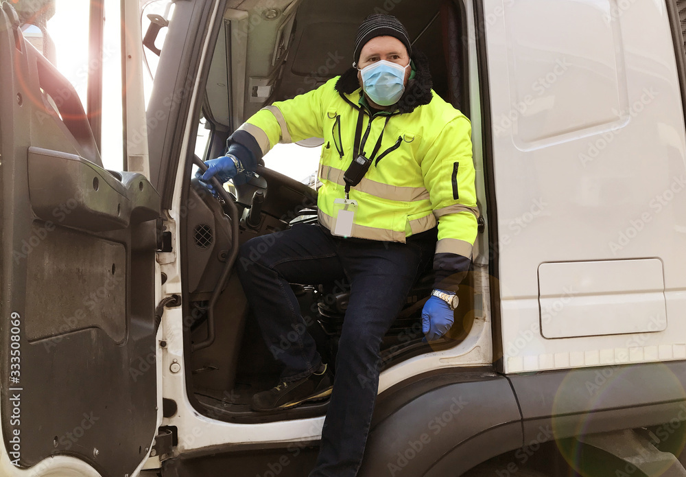 young transporter on the truck with face mask and protective gloves for Coronavirus - obrazy, fototapety, plakaty 