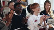 © vadim_key - Happy young multiethnic business people sit and applause, listening to seminar smiling at modern office conference.