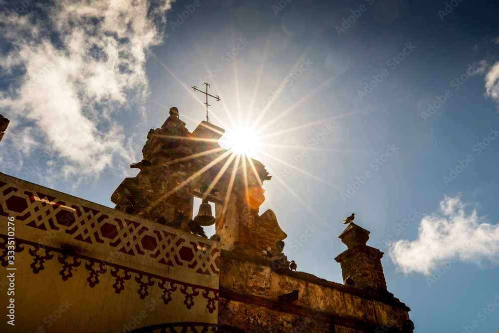 The sun flares off the top of the Capilla del Santo Cristo de la Salud ...