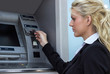 © sanjagrujic - Businesswoman withdrawing money from credit card at ATM