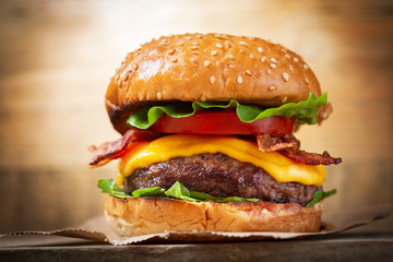 burger with cheese, bacon, salad and vegetables