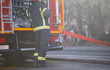 © luckybusiness - Fireman in uniform in front of fire truck going to rescue and protect. Emergancy servise concept.