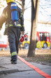 © luckybusiness - Fireman in uniform in front of fire truck going to rescue and protect. Emergancy servise concept.