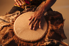 Detail Of African American Man Musician Playing Traditional Drums At Brown Background. Online Musical Class. Leisure Learning Musical Instruments. Rhythm And Blues Style. Ethnic Traditions.