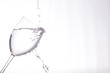 clear liquid pouring into a wine glass