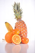 fruit composition with pineapple orange banana mandarin isolated on white background