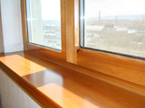 Fototapeta Tulipany - a window and a window sill from larch, from a natural tree, repair in a house installation of high-quality windows