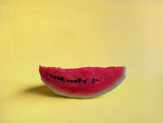 Watermelon slice on yellow background. tropical fruit concept